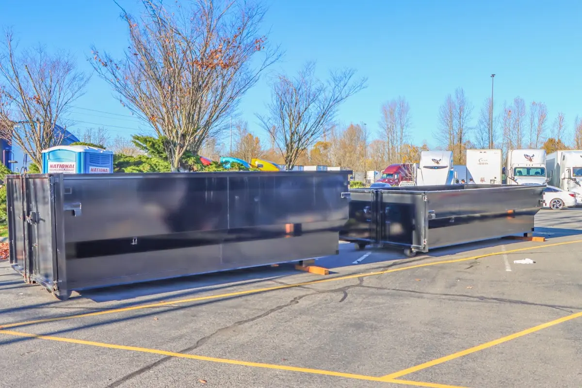 Professional dumpster rental service with roll-off container on residential driveway in The Crossings